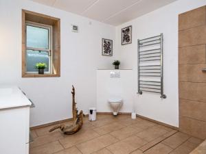 a bathroom with a toilet and a window at Panoramic Retreat by Water - By Traum Ferienwohnungen in Børkop +24 photos