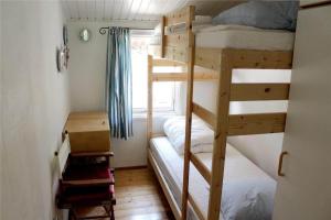 a bedroom with two bunk beds and a window at 12255-Sjaellands-Odde-Klokkelyngvej-5 in Tjørneholm