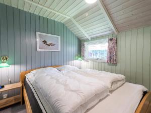 a large bed in a room with green walls at 6 person holiday home in Nørre Nebel in Nørre Nebel