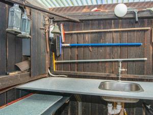 a bathroom with a sink in a wooden wall at 4 person holiday home in Grenaa-By Traum in Grenå +24 photos