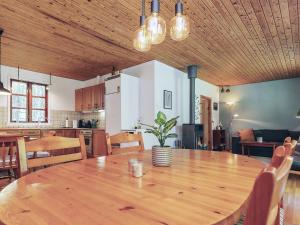 a dining room and kitchen with a wooden table at 4 person holiday home in Læsø in Læsø