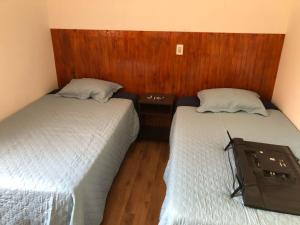 two beds sitting next to each other in a room at casa para empresa o vacaciones in Iquique +6 photos