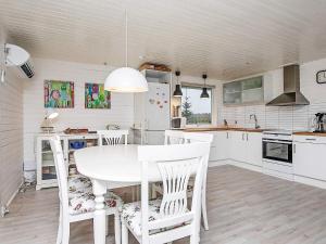a white kitchen with a white table and chairs at 5 person holiday home in Hals-By Traum in Hals +8 photos