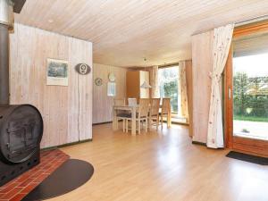 a living room with a fireplace and a dining room at 6 person holiday home in Løkken-By Traum in Løkken