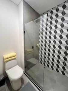 a bathroom with a toilet and a shower at Tu espacio acogedor en el Centro Internacional in Bogotá +10 photos