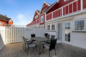 a patio with a table and chairs and a fence at 11203-Nykobing-Sj-Havnevej-63-st-th in Nykøbing Sjælland