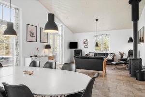 a dining room with a white table and chairs at 0003-Romo-Vestervej-39 in Toftum
