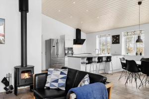 a living room with a couch and a stove at 0003-Romo-Vestervej-39 in Toftum