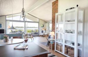 a kitchen and living room with a dining room at 14249-Grevinge-Strandmosen-4 in Grevinge