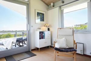 a living room with a door open to a balcony at 14249-Grevinge-Strandmosen-4 in Grevinge
