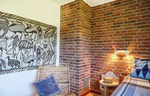 a bedroom with a brick wall with a bed and a brick wall at 14249-Grevinge-Strandmosen-4 in Grevinge