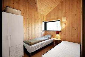 a small bedroom with a bed and a window at 10067-Nykobing-Sj-Niels-Jensens-Vaenge-2 in Rørvig