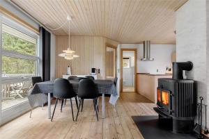a living room with a table and a stove at 11130-Nykobing-Sj-Vindingsvej-24 in Nykøbing Sjælland