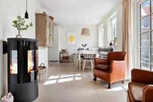 a living room with a fireplace and a dining room at LK1397-Lokken-Norregade-30-a in Løkken