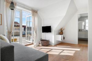 a living room with a couch and a large window at LK1397-Lokken-Norregade-30-a in Løkken