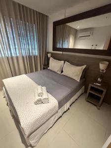 Ένα ή περισσότερα κρεβάτια σε δωμάτιο στο Grand Midas Rio Convention Suítes