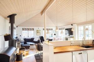 a kitchen and a living room with a couch at 10014-1-Rorvig-Troldevaenget-5 in Rørvig