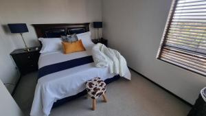 a bedroom with a large bed with colorful pillows at 391 at SoHo in Sandton +15 photos