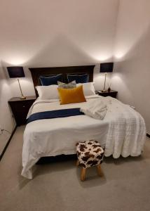 a bedroom with a large bed with two lamps at 391 at SoHo in Sandton