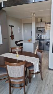 a kitchen and dining room with a table and chairs at 391 at SoHo in Sandton