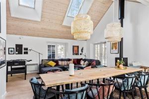 a living room with a wooden table and chairs at 16610-Farevejle-Mejsevaenget-26 in Fårevejle