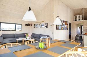 a living room with a couch and a table and chairs at 17715-Follenslev-Ravnholt-62 in Føllenslev