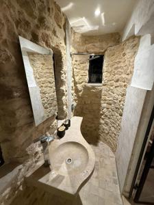a stone bathroom with a toilet and a sink at Casa Dea - Bungalow Aphrodite in Hammamet Sud +1 photo