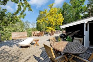 a patio with a table and chairs and a grill at 11826-Nykobing-Sj-Lynglodden-5 in Nyrup +14 photos