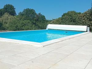 a swimming pool with a bench on a patio at Maison neuve à Sarlat avec jardin et terrasse - FR-1-616-488 in Sarlat-la-Canéda