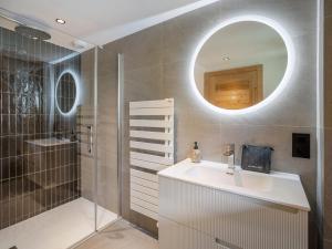 a bathroom with a sink and a shower and a mirror at Appartement neuf au pied des pistes, sauna, 5 chambres pour 12 personnes - FR-1-570-71 in Levassaix