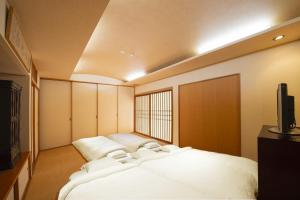 Cama ou camas em um quarto em 宿坊心泉