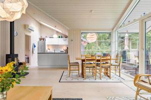 a kitchen and dining room with a table and chairs at 11802-Nykobing-Sj-Gogetoften-10 in Nyrup +14 photos