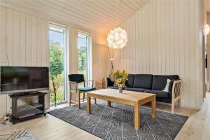a living room with a couch and a table at 11802-Nykobing-Sj-Gogetoften-10 in Nyrup