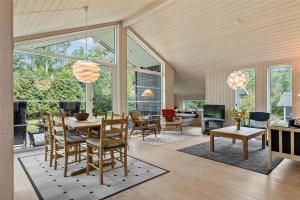 a living room with a table and chairs at 11802-Nykobing-Sj-Gogetoften-10 in Nyrup