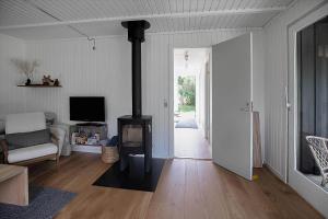 a living room with a wood burning stove in it at 12215-Sjaellands-Odde-Granitager-8 in Tjørneholm