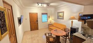 a living room with a table and a couch at The Palmana Courtyard Jayakarta Residence 6 in Seminyak