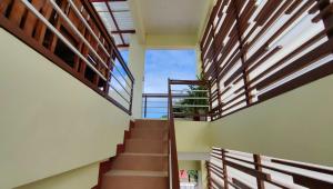 a staircase in a house with wooden railings at Pring Pension House Puerto Princesa in Puerto Princesa City