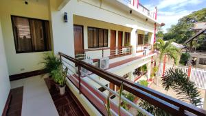 a balcony of a building with plants on it at Pring Pension House Puerto Princesa in Puerto Princesa City