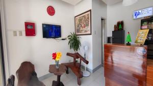 a living room with a table and a chair at Pring Pension House in Puerto Princesa City +54 photos