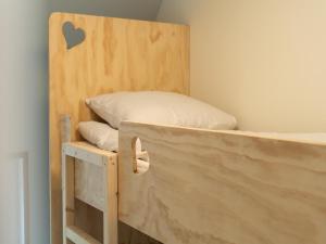 a bunk bed in a room with a bed frame at Holiday Home in Forest near Pond in Baars