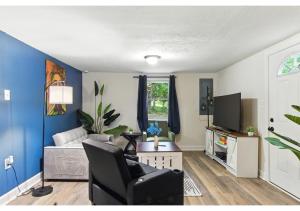 a living room with a couch and a chair at Mountain Bungalow - Nature, History -Wineries - PS5 in Harpers Ferry
