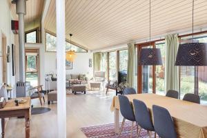 a dining room and living room with a table and chairs at 10010-1-Rorvig-Sommervej-3 in Rørvig +25 photos