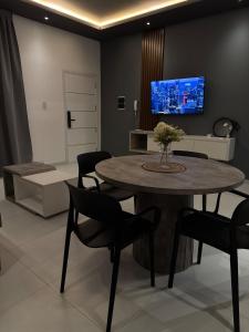 Una sala de estar con una mesa y sillas y un televisor. en Isi house, en Morteros