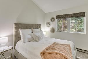 a white bedroom with a large bed with white pillows at Hike, Ski and Golf Fully Renovated Edwards Townhome in Edwards