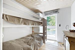 a bedroom with two bunk beds and a window at 11153-Nykobing-Sj-Lyngvejen-27 in Nykøbing Sjælland