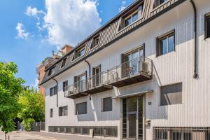 a white building with balconies on the side of it at Vaga's Nest - Modern Studio Apartment in Milan