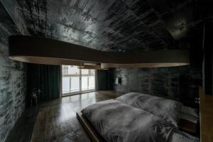 a bedroom with two beds and a large window at MN Building - Vacation STAY 11195 in Nagoya