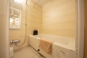 a bathroom with a bath tub and a shower at MN Building - Vacation STAY 11196 in Nagoya