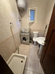 a bathroom with a toilet sink and a washing machine at Morning Star Guesthouse in Sharm El Sheikh +38 photos