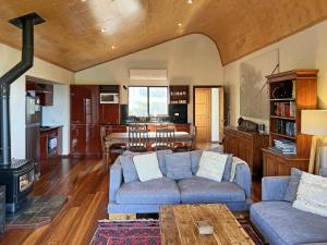a living room with a couch and a table at Serendeva: Stunning views, private & EV charger in Denmark